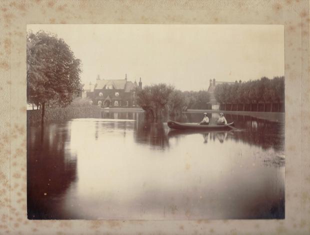 Kate Frye and her sister, Agnes, paddling a canoe on the lawn of their home, The Plat, at Bourne End, Buckinghamshire in October 1891