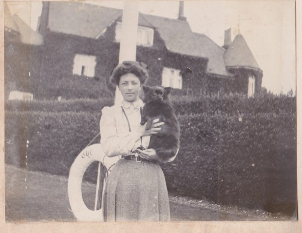 Kate with Mickie. Photographed on the riverside at Bourne End, with The Plat, which until 1913 was her home, in the background